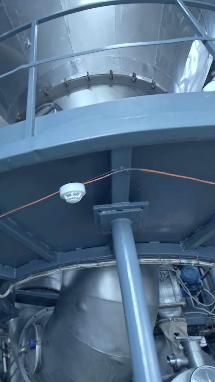 Manufacturing for milk products indoors. Stainless equipment inside the dairy factory. Modern milk production factory.. Vertical video