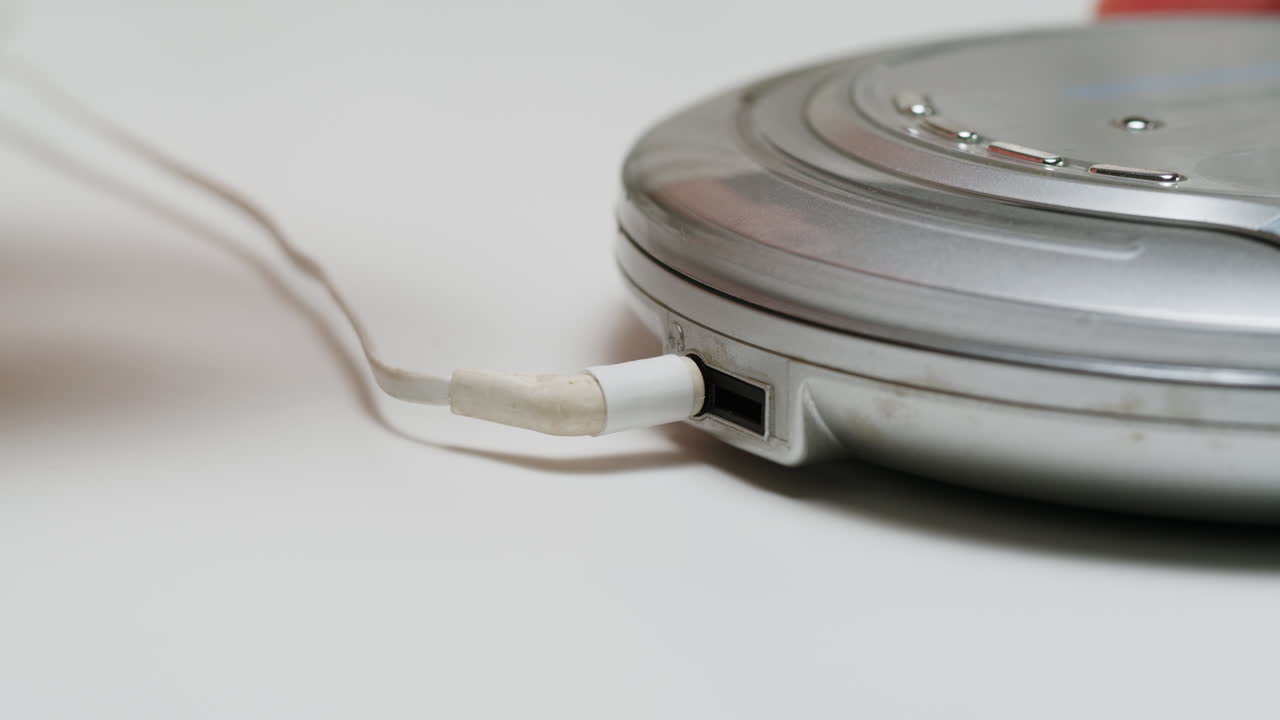 Using headphone for old music portable compact player close-up. Listen to music with vintage player.