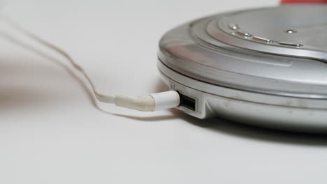 using headphone for old music portable compact player close-up. listen to music with vintage player.