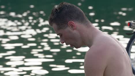 athlete breathes deeply after swimming in the lake