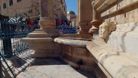 Tilt-up-of-the-Muristan-fountain-running-trickle-of-water,-Old-City-Jerusalem