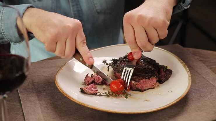 Muž jí steak v restauraci