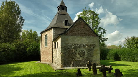 tiny old chapel with gravestones, dolly in tilt up low angle, offelken