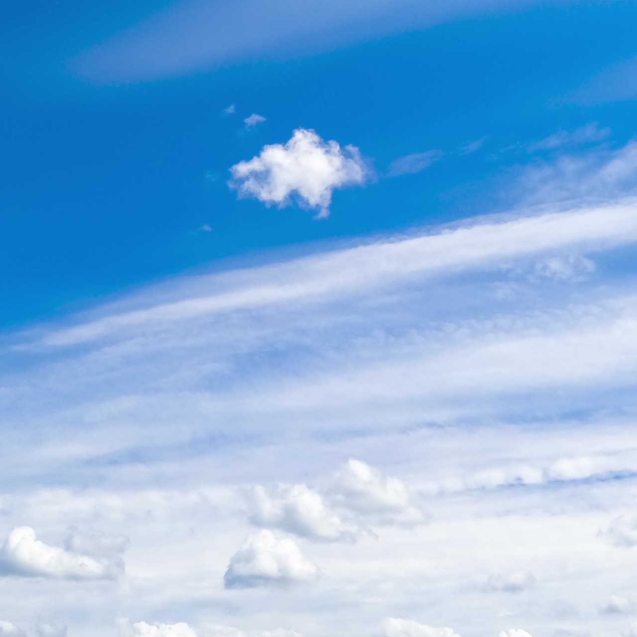 Heavenly beautiful blue skies with white clouds floating by. Cumulus and spindrift clouds transforming in the atmosphere. Timelapse
