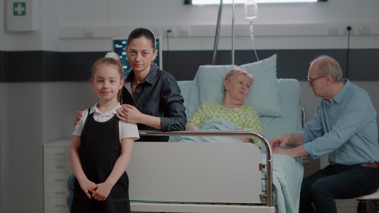 Portrait of mother and child sitting in hospital ward at family visit