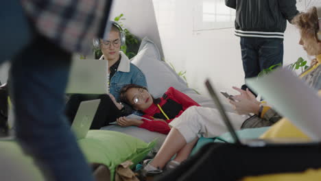 young-group-of-business-people-students-working-tired-asian-woman-sleeping-resting-after-studying-in-busy-office