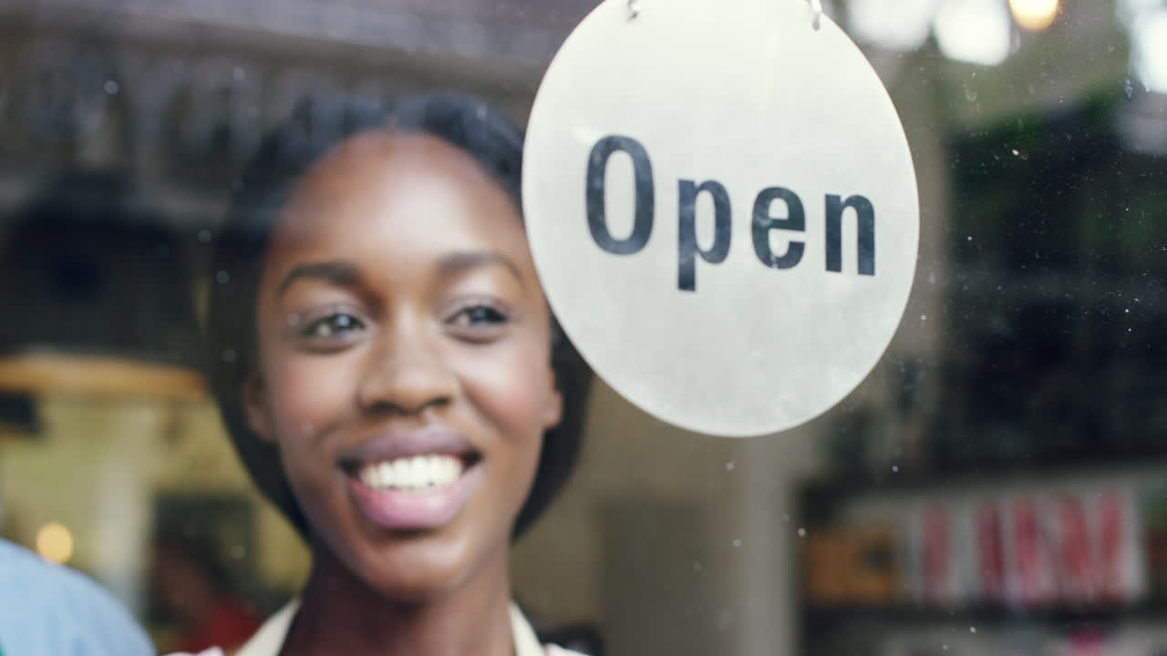 Small business owner turning over open sign