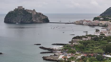 panoramic view of ischia port town with aragonese castle in the gulf of naples, italy