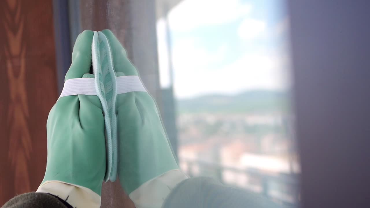 Cleaning Windows with Gloves and Sponge