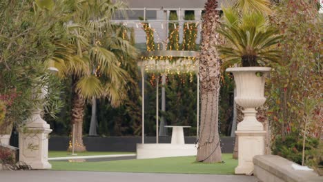 wedding altar with palm trees and lights in portugal garden venue