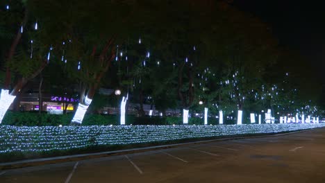 cascading christmas lights gliterring in the night in the middle of the city of bangkok in thailand