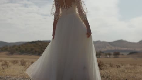 Happy-Bride-In-White-Dress-Spinning-In-Countryside-Field