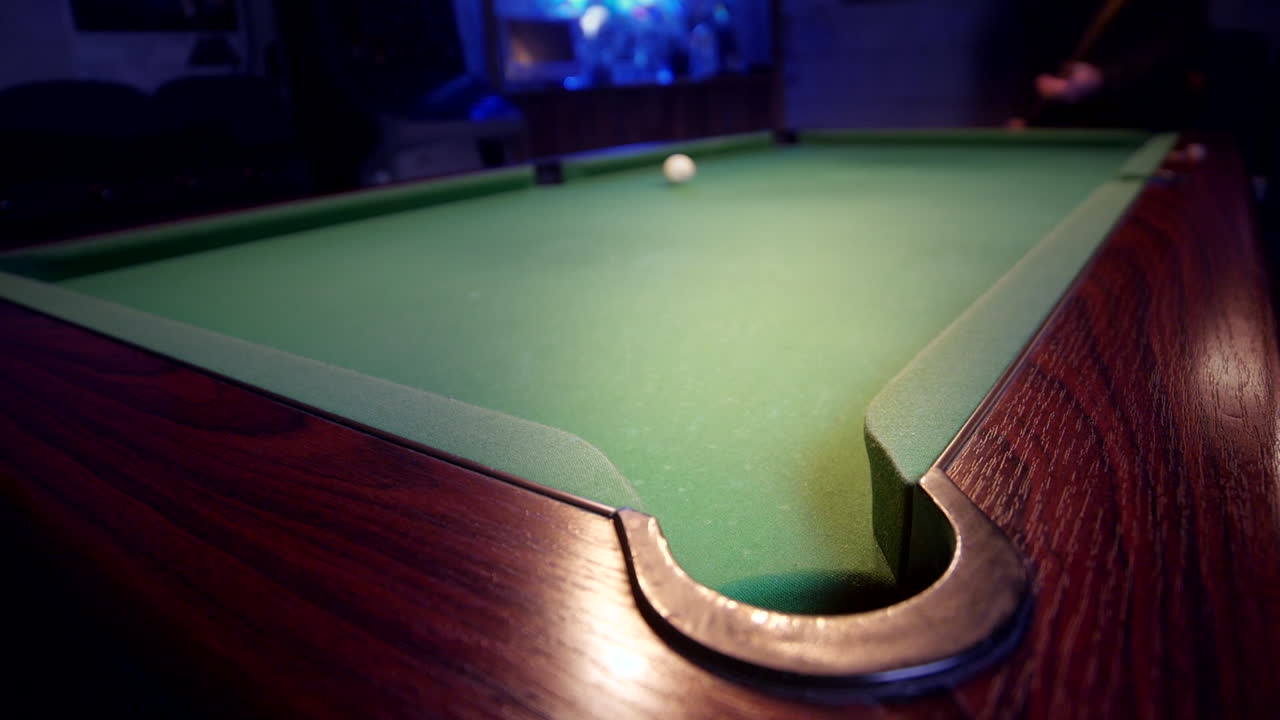 The eight ball is potted on a green pool table