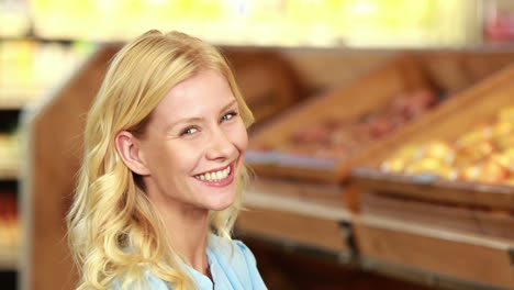 smiling blonde choosing apple