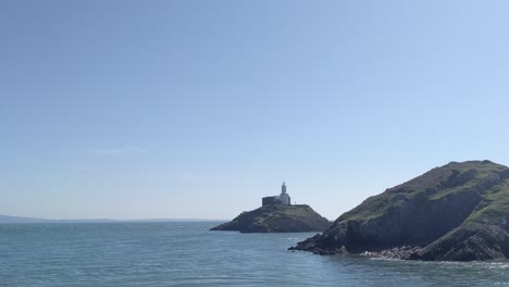 Lighthouse-on-Small-Island-with-Calm-Sea-on-Sunny-Day