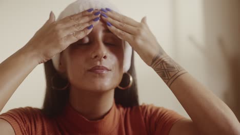 woman applying skincare products to her face
