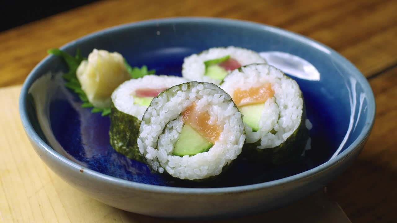 los rollos de sushi de salmón y atún se colocan en el plato para servir