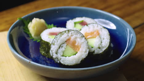 Salmon-and-Tuna-Sushi-Rolls-Being-Place-on-Plate-for-Serving