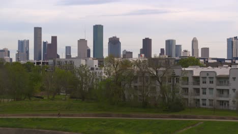 Ascending-drone-shot-from-the-Buffalo-Bayou-that-reveals-downtown-Houston,-Texas