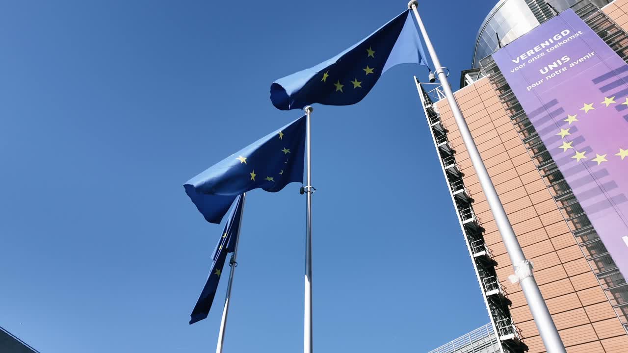 European Union flags waving outside the Berlaymont building in Brussels