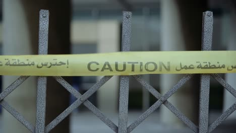 Yellow-caution-tape-with-Arabic-and-English-font