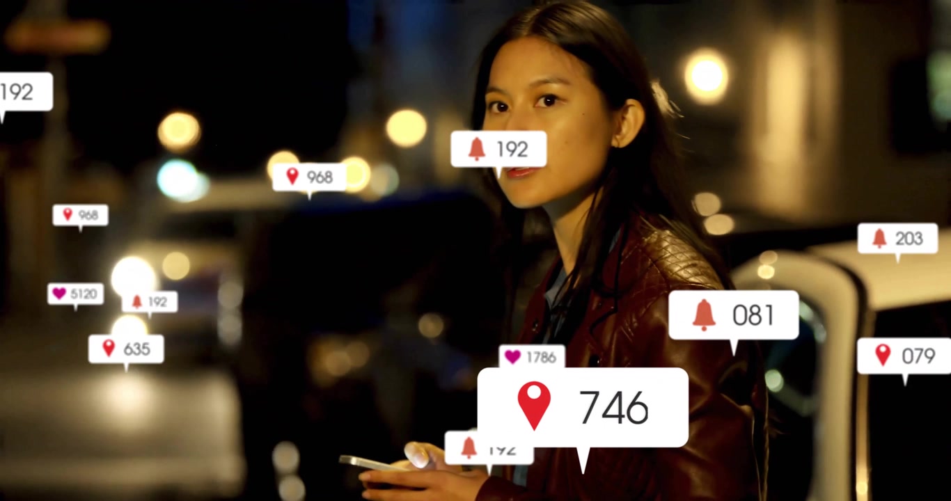Mid adult female scrolling phone beside car creating tech alert bubbles before noticing headlights