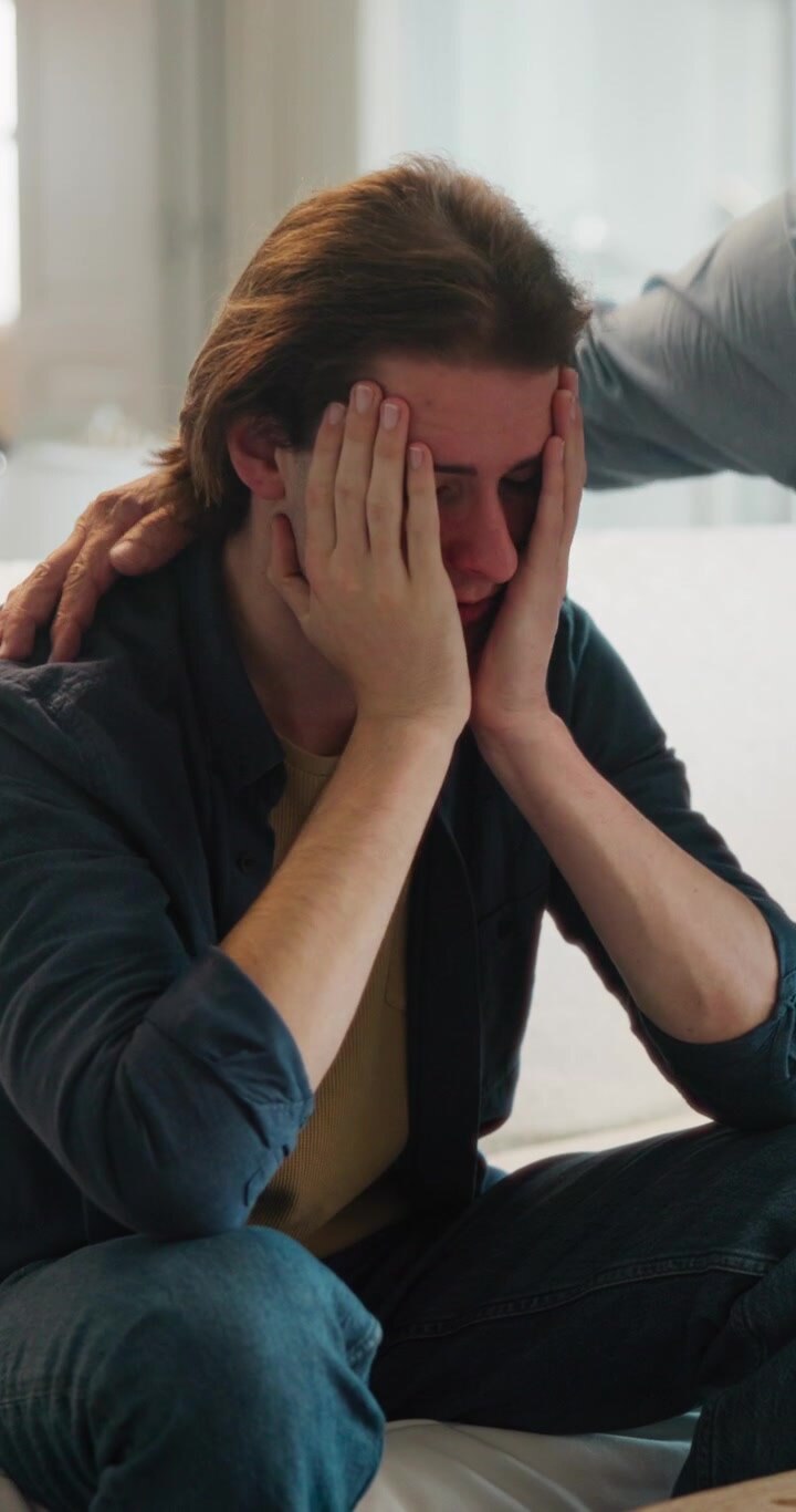 Young Man Receiving Comfort and Support from Friend