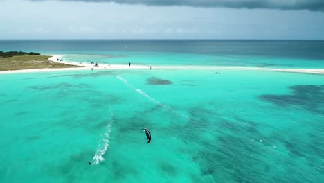 Stunning-footage-of-Kite-surfers-sailing-on-clear-waters-at-Cayo-De-Agua,-Los-Roques