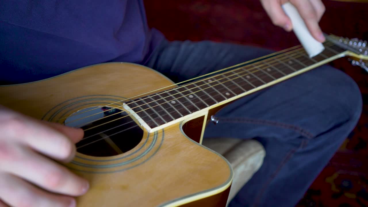 Close-up of acoustic guitar being cleaned