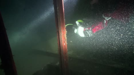 diver reels in the line on the way out of the wreck