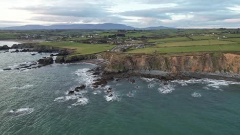 drone flight from the sea to stage cove copper coast waterford with the comeragh mountains in the background