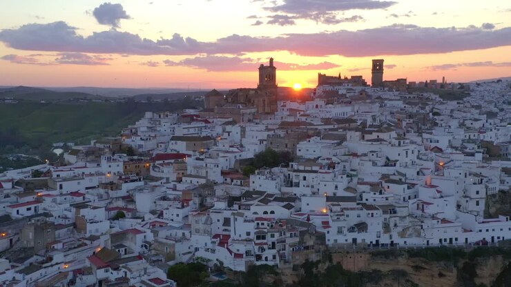 White town on cliff at sunset