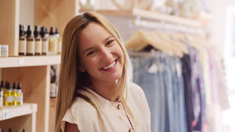 Portrait-Of-Young-Woman-Having-Fun-Shopping-In-Clothing-And-Gift-Store