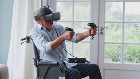 hombre discapacitado en silla de ruedas en casa con auriculares de realidad virtual sosteniendo controladores de juegos