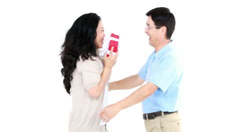 asian man giving a gift to his wife