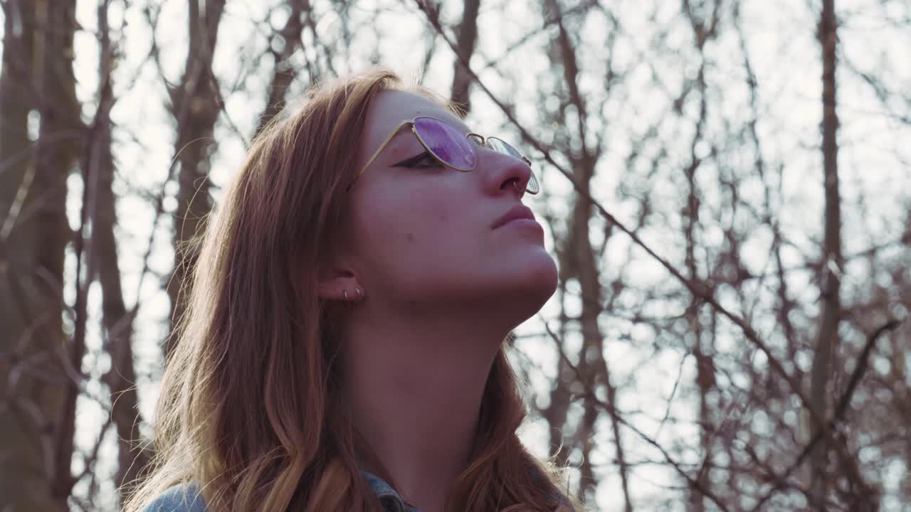 Girl looking around in a Forrest - Slowmotion