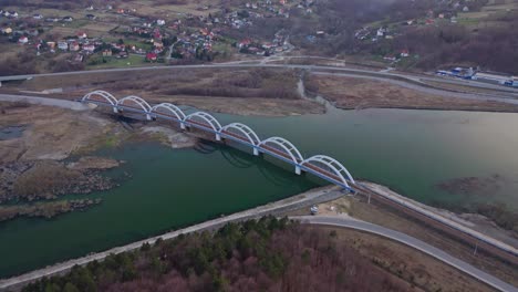 railway arch bridge over the skawa river within the lake mucharskie in poland