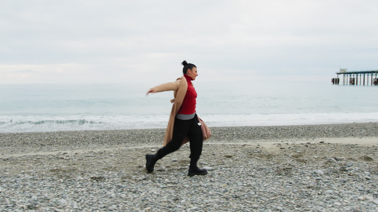 On The Oceanside A Woman Walks Dancing Classical Dance In Energetic Musical Mood