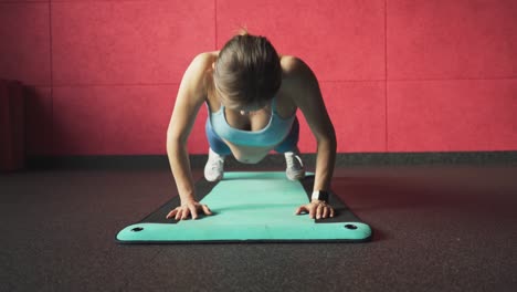 pregnant woman doing fitness exercises in gym. pregnant woman doing push ups