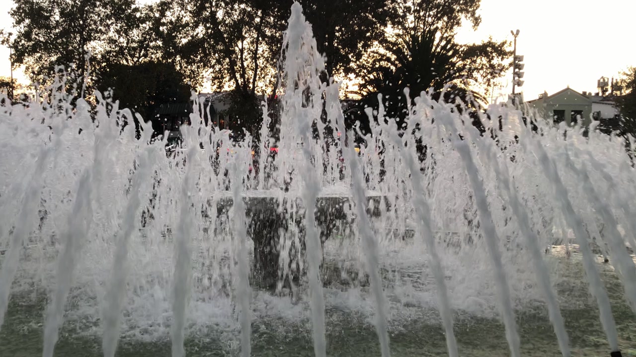 Circular fountain arrangement with metal nozzles on grey stone pavement in a modern square project. Urban aesthetics, landscape architecture, and water feature detail.