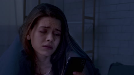 upset woman using phone at night