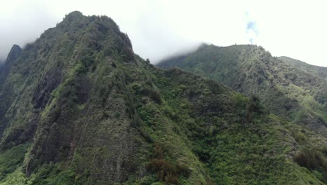 white clouds hovering over the mountain peaks of iao valley