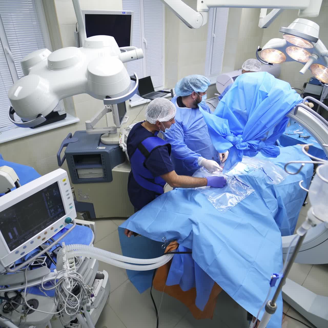 Operation with doctors at hospital. Team of cooperative medical staff processing surgery at hospital