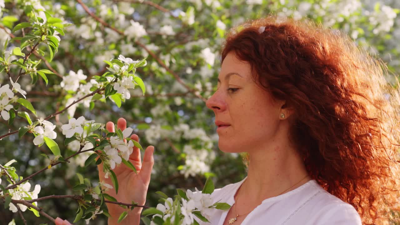 Woman enjoying spring apple blossoms