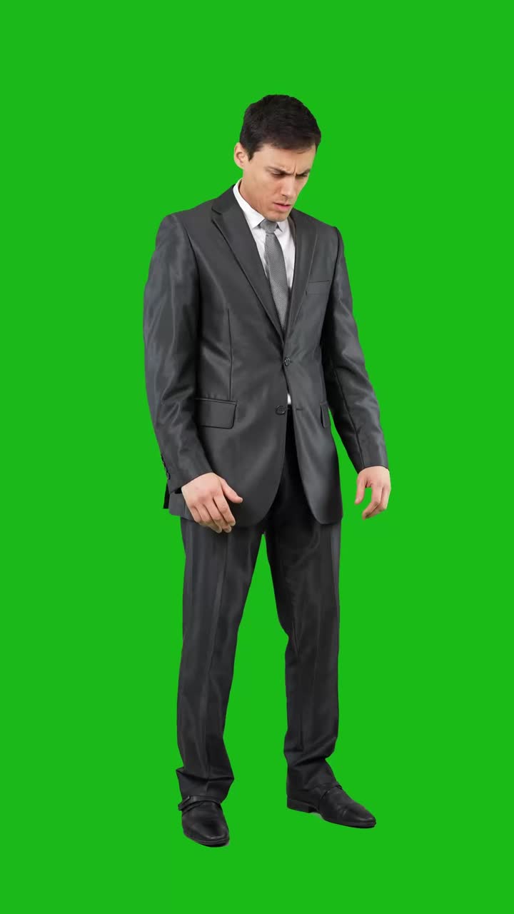 Businessman in Suit on Green Screen Looking Up