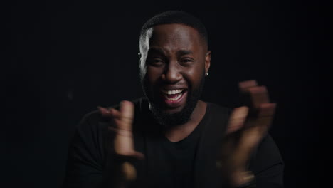 African-american-man-gesturing-in-studio.-Afro-guy-posing-indoors