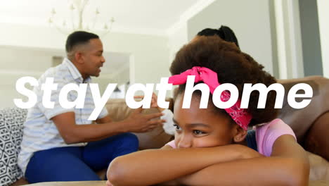 animation of stay at home text over parents with daughter at home