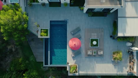 aerial dolly shot revealing a swimming pool in the garden of a villa in france