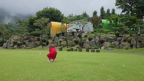 baby girl catches soap bubbles in a grassy lawn