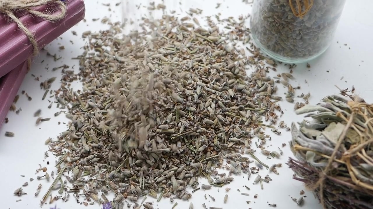 Dried Lavender Buds Pouring onto White Surface